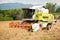 Combine harvesting grain on a hot summer afternoon - agricultur