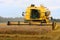 Combine harvesting wheat