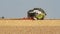 Combine harvesting wheat