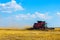 Combine harvesting wheat