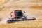 Combine harvesting wheat in the Palouse hills