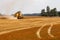 A combine mowing grain during harvest. Field work carried out by farmers