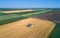 Combine pouring wheat grain trailer during harvest