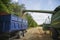 The combine pours wheat into the tractor trailer with a grain auger.