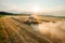 Combine reaper with dust gathers rye in agricultural field