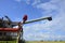 Combine removes rapes on the field. Rapeseed harvesting by combine on summer field