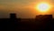 The combine at sunset unloads grain on a dumper.