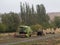 Combine and a tractor parked in the yard of a farm