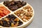 combined plate with dried fruits and nuts. in each compartment of the plate there is food