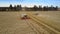 Combines harvest rich wheat crop making straw rolls in field