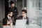 Combining their expertise. Youngindian handsome man in eyeglasses gesturing and discussing something while his coworkers listening