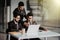 Combining their expertise. Youngindian handsome man in eyeglasses gesturing and discussing something while his coworkers listening