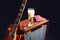 Combo amplifier for electric guitar with guitar, glass of beer and notepad on black background