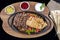 Combo Fajita; top down photo of mexican steak and chicken fajitas in iron skillet with corn tortillas