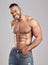 Come in the gym like youre going to war. Studio shot of a young muscular man posing against a grey background.