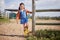 Come have fun with me on our farm. an adorable little girl playing outside on the farm.