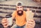 Come hungry, leave happy. Cheerful man with snacks. Happy man holding hot dog and drink. Bearded man smiling with