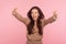 Come into my arms! Portrait of delighted happy young woman with brunette wavy hair raising hands to hug you tightly