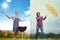 Come on over to the sunny side. Composite shot of a man barbequing on a sunny day while a a woman fights against the