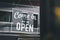 Come in we\\\'re open, vintage black retro sign in glass door storefront