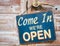 Come In We\'re Open on the wooden door, retro vintage style