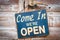 Come In We\'re Open on the wooden door, retro vintage style