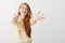 Come to me, let me hug you. Studio shot of thrilled overwhelmed redhead female pulling hands towards camera with