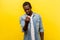 Come to me. Portrait of handsome man making beckoning gesture and smiling. indoor studio shot isolated on yellow background