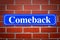 Comeback street sign on brick wall