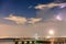 Comet Neowise, setting over a fishing pier with lightning to the side. Long Island New York