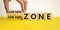 Comfort or learning zone symbol. Hand turns wooden cubes and changes words `comfort zone` to `learning zone`. Beautiful yellow