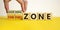 Comfort or learning zone symbol. Hand turns wooden cubes and changes words `comfort zone` to `learning zone`. Beautiful yellow