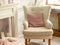 Comfortable beige armchair in a modern classic designer interior