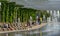 Comfortable benches with climbing Aristolochia plant under pergola.   Fountain Three streams turning into complex of fountains