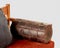 Comfortable brown leather bolster cushion on wooden sofa