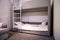 Comfortable bunk bed family bedroom concept idea. Stylish kids bedroom. Model of designed children bedchamber displayed for sale