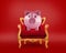 Comfortable red and golden armchair with a piggybank. Concept as premier savings service