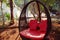 Comfortable sofa. Desk set in nature. Large round sofa with red cushion set in a natural forest.