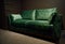 Comfortable upholstered velour green couch displayed for sale in the furniture store showroom. Exhibition of upholstered furniture