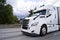 Comfortable white modern big rig semi truck running on divided h