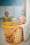 So comfy we might just take a snooze in here. Portrait of two young girls sitting in laundry baskets.