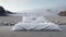 Comfy white master bed on the black sand surrounded by Iceland landscape.