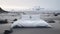 Comfy white master bed on the black sand surrounded by Iceland landscape.