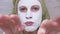 Comic Appearance of a Woman with a Mask of White Clay on Face. Close up. 4K