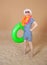 Comic funny man in vintage style striped swimsuit, colorful boa