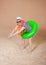 Comic funny man in vintage style striped swimsuit, colorful boa and sunglasses ready to dive with inflatable ring