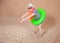 Comic funny man in vintage style striped swimsuit, colorful boa and sunglasses ready to dive with inflatable ring