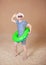 Comic funny man in vintage style striped swimsuit and sunglasses posing with inflatable ring on sand