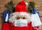 Comic image of Santa Claus in a hat, made up of a medical mask, gloves, glasses and hand sanitizer. Use protective gear to avoid