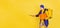 Comic portrait of young man, delivery guy in uniform isolated on yellow studio background. Concept of humor, safety